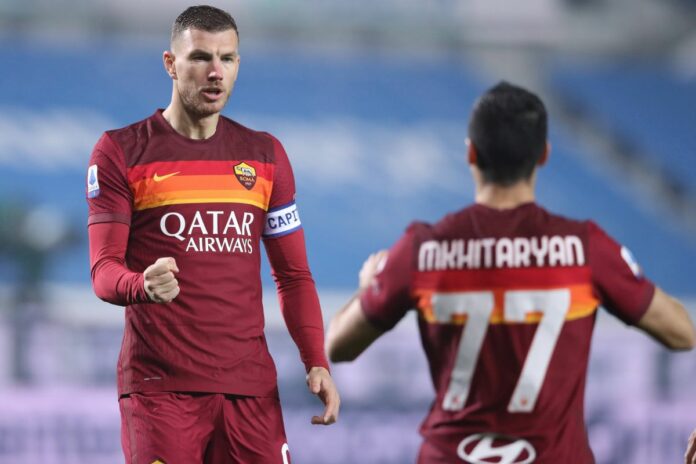 Edin Dzeko of AS Roma celebrates with team mate Henrikh Mkhitaryan after scoring to give the side a 1-0 lead during the