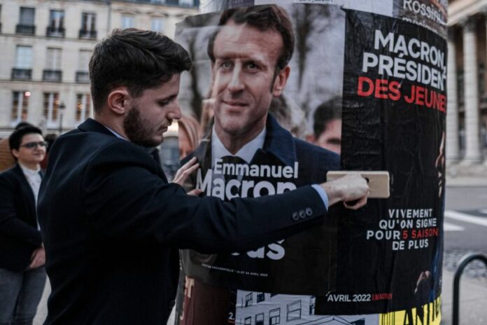 2022 French presidential election-En Marche activist sticking posters