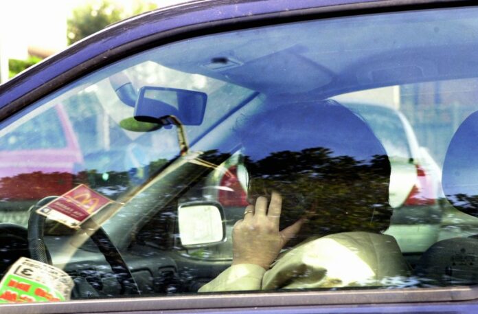 GENTE CHE GUIDA IN AUTO CON IL TELEFONINO