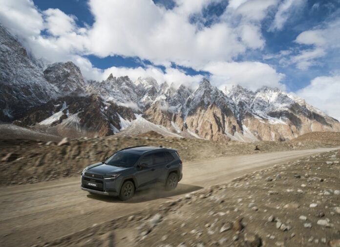 Minivan on Karakoram Highway with mountain in background